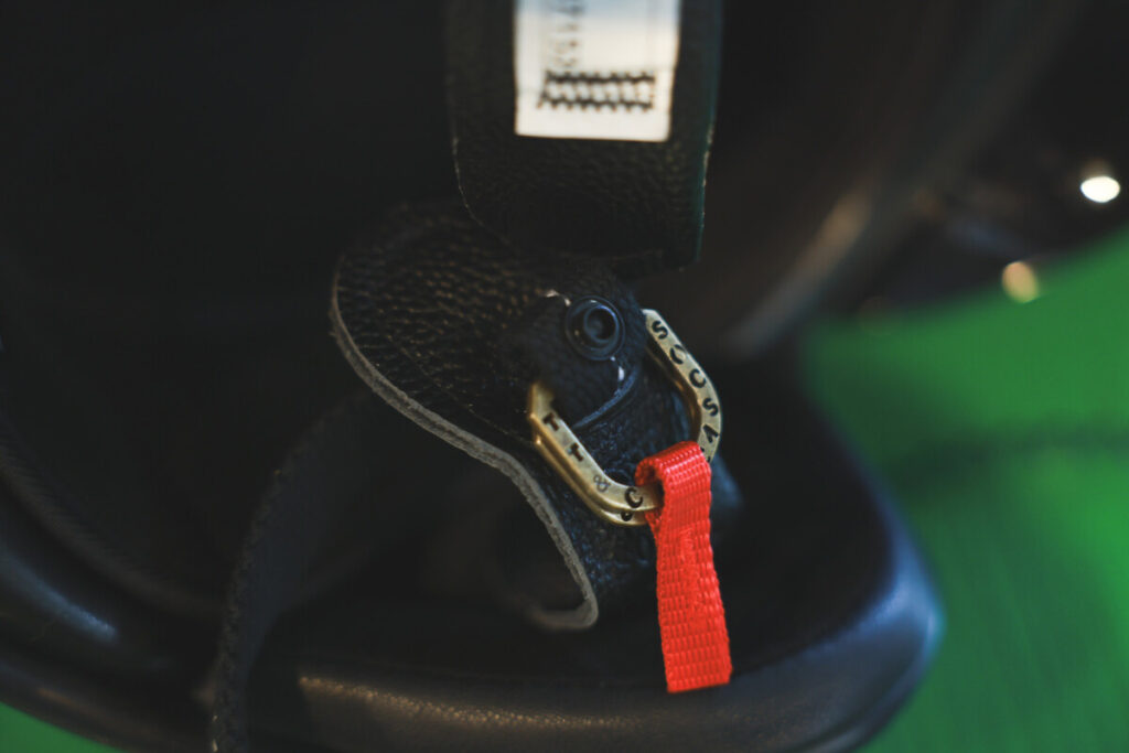 It features a D-ring closure for secure fastening.