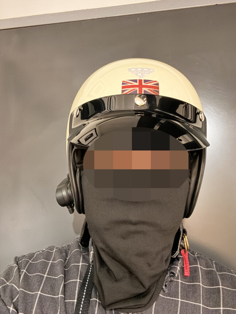 Side view of a rider wearing a slim-shell helmet that enhances small-face appearance