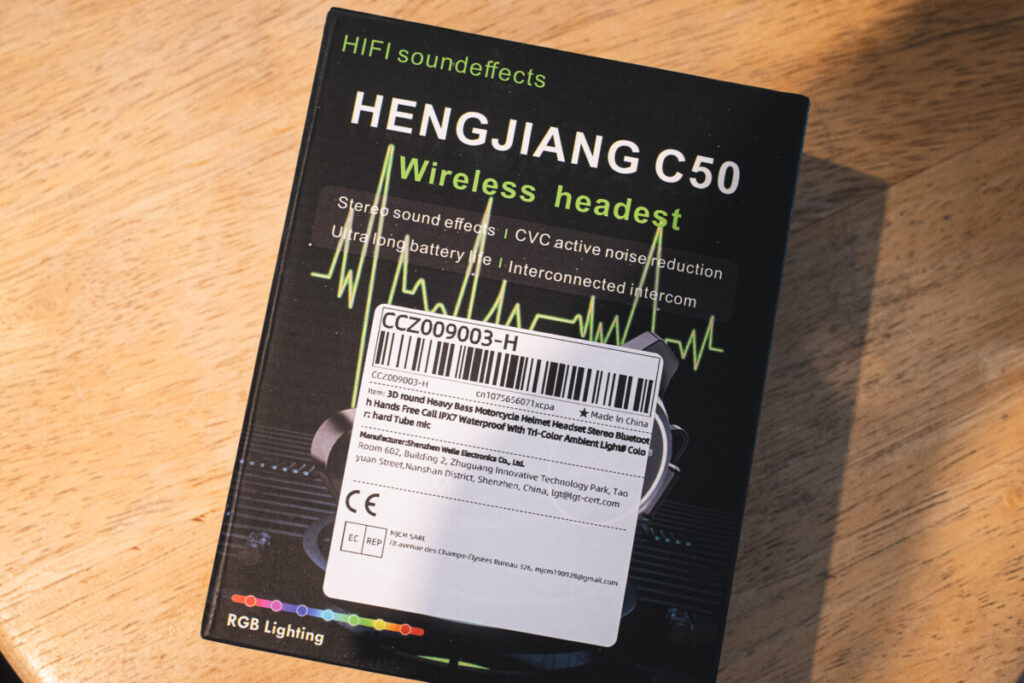 "Retail packaging of the HENGJIANG C50 wireless Bluetooth headset, featuring product highlights such as stereo sound, CVC noise reduction, long battery life, and intercom support, with a shipping label attached."