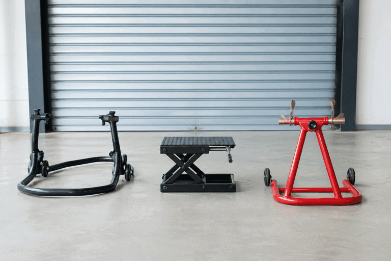 Scissor lift stand and paddock stand placed side by side for motorcycle maintenance comparison