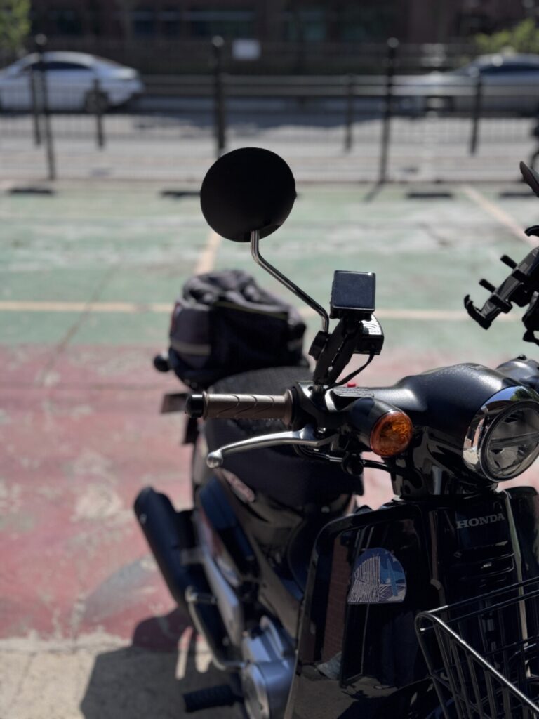 "Honda Super Cub parked with 3R blind spot mirror mounted — real world installation"