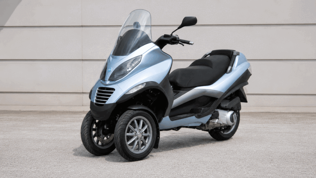 Piaggio MP3 parking system — stands without kickstand using locking mechanism
