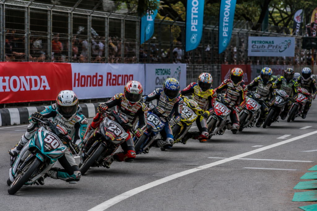 Professional underbone motorcycle racers competing on Malaysian Cub Prix street circuit