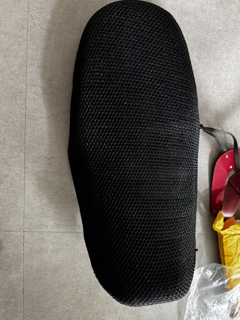 Stretching the seat cover tightly over the Honda CL500 seat during installation-2