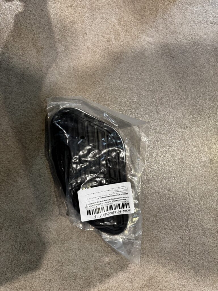 Pair of black vintage-style motorcycle tank pads in AliExpress packaging
