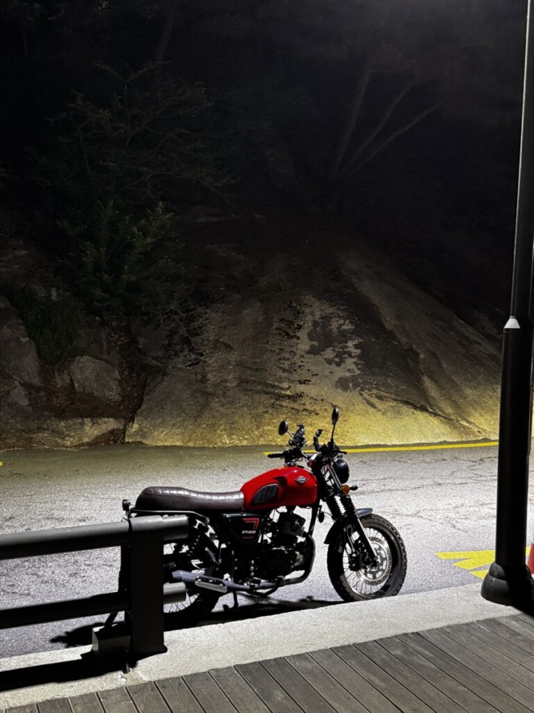 Keeway SR125 parked on the steep Doseonsa temple road under mountain street lights