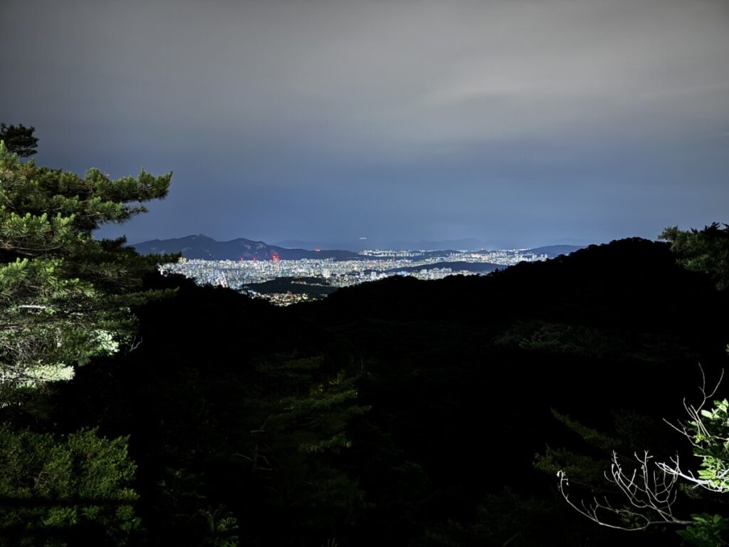 Wide night view of Seoul city lights from the mountain road near Doseonsa temple